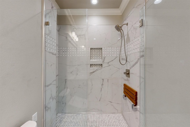 bathroom featuring ornamental molding and a shower with door