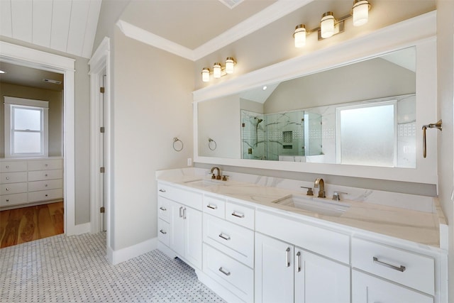 bathroom featuring vanity, crown molding, hardwood / wood-style flooring, lofted ceiling, and a shower with shower door