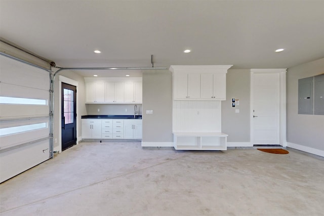 garage featuring electric panel and sink