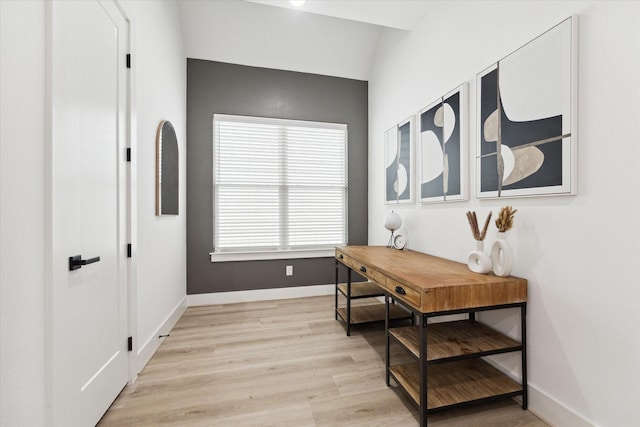 interior space with lofted ceiling and light hardwood / wood-style flooring