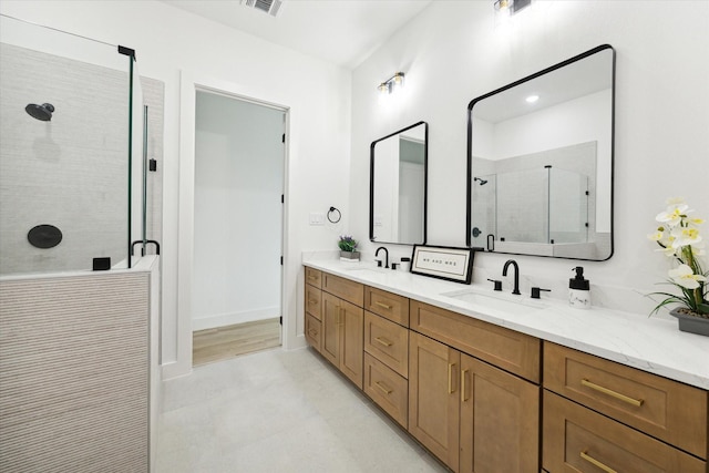 bathroom featuring vanity and a shower with shower door