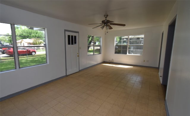 empty room with a wealth of natural light and ceiling fan