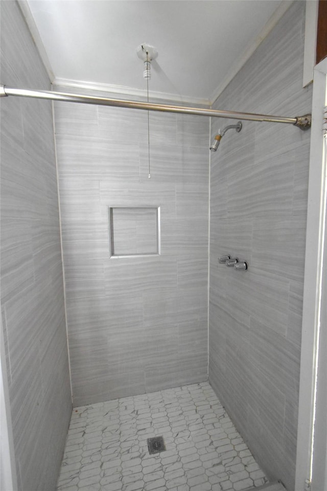 bathroom with a tile shower