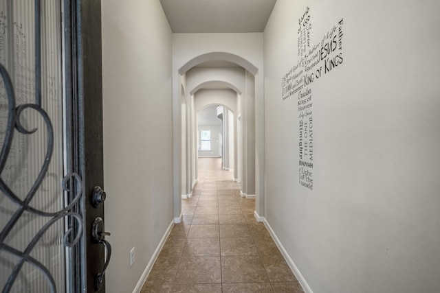 corridor featuring dark tile patterned floors