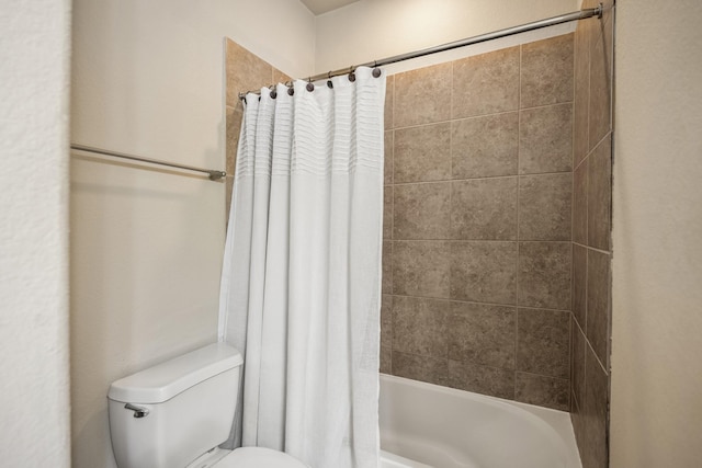 bathroom with shower / bath combo and toilet