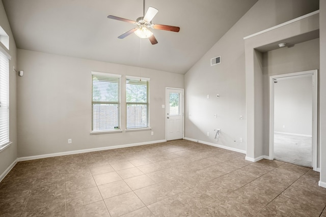 empty room featuring high vaulted ceiling, ceiling fan, and light tile patterned flooring