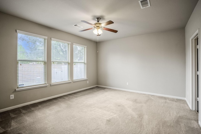 spare room with carpet and ceiling fan