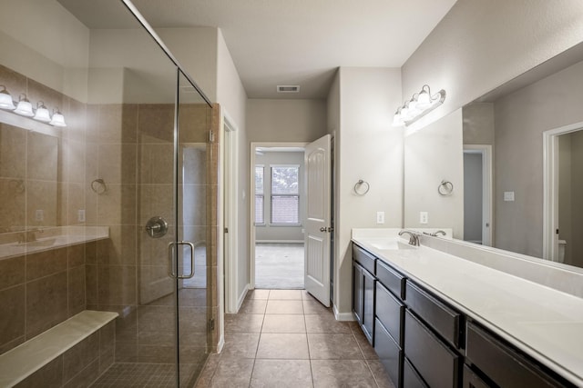 bathroom featuring tile patterned floors, vanity, and an enclosed shower