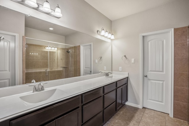 bathroom featuring a shower with door, vanity, and tile patterned flooring