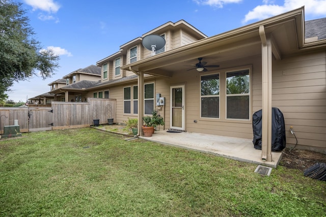 back of house featuring a patio area, ceiling fan, and a yard