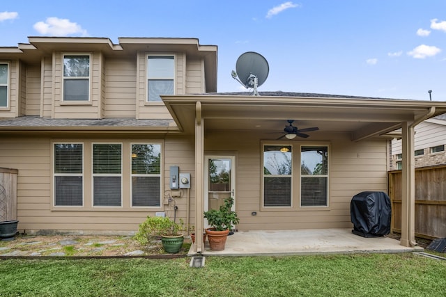 rear view of house featuring a patio area, ceiling fan, and a yard