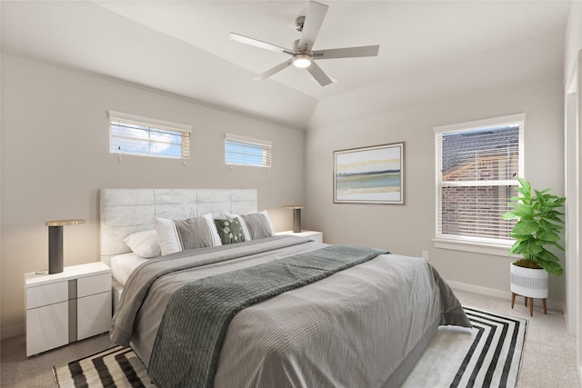 bedroom with multiple windows, ceiling fan, light carpet, and lofted ceiling