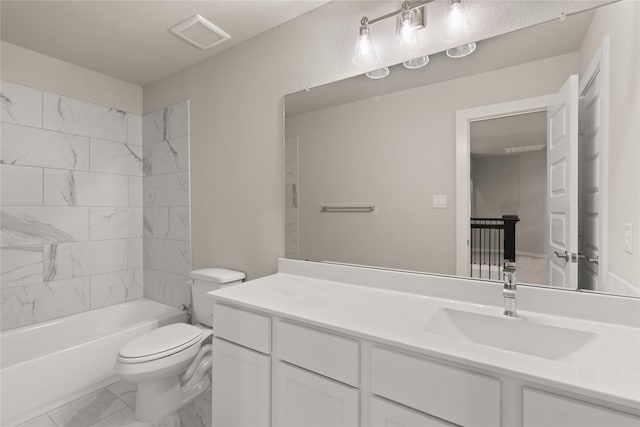 full bathroom featuring vanity, tiled shower / bath combo, and toilet