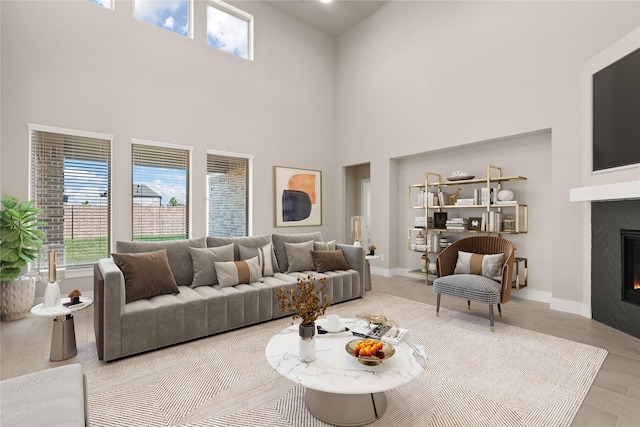 living room with a towering ceiling and light hardwood / wood-style floors