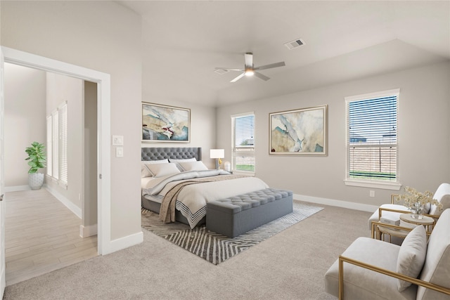 bedroom with light wood-type flooring, multiple windows, and ceiling fan