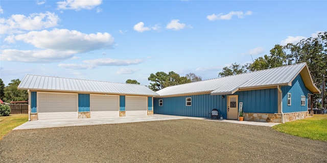 single story home featuring a garage and an outdoor structure