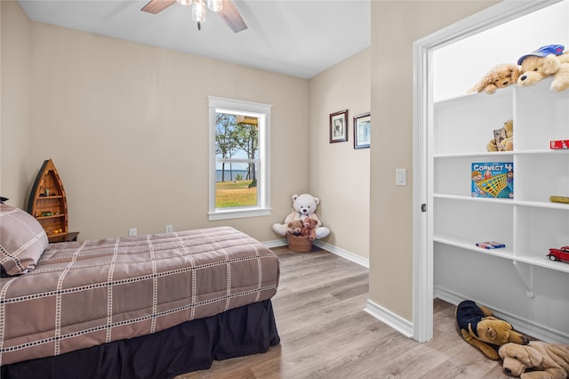 bedroom with light wood-type flooring and ceiling fan