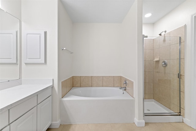 bathroom with tile patterned floors, separate shower and tub, and vanity