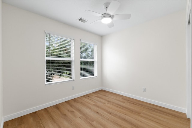 empty room with ceiling fan and light wood-type flooring