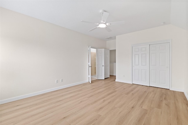 unfurnished bedroom featuring a closet, ceiling fan, light hardwood / wood-style flooring, and lofted ceiling