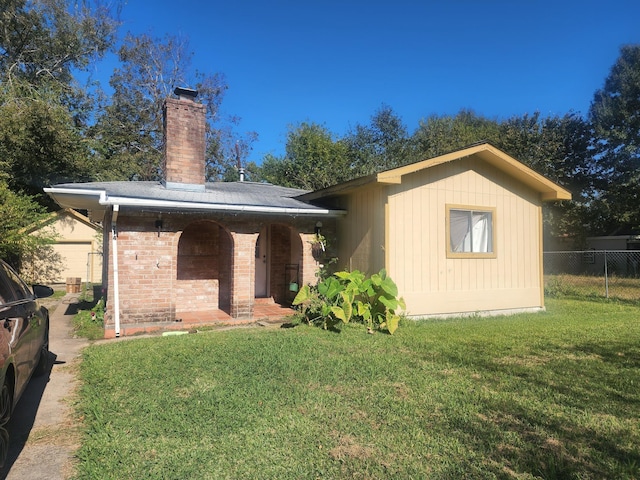 rear view of house with a yard