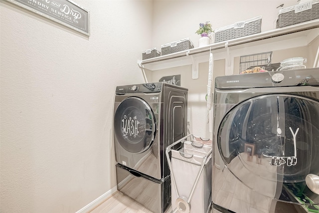 laundry area featuring wood-type flooring and independent washer and dryer