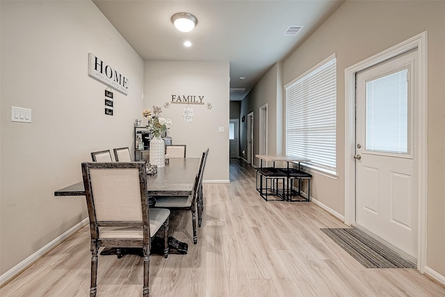 dining area with light hardwood / wood-style floors