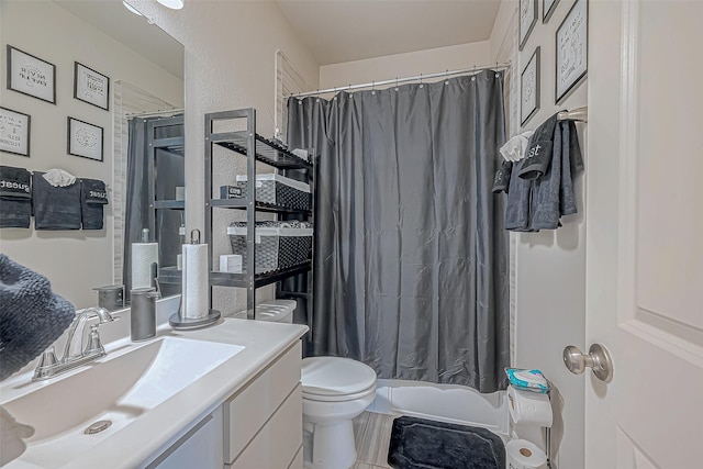 bathroom with tile patterned flooring, vanity, toilet, and walk in shower