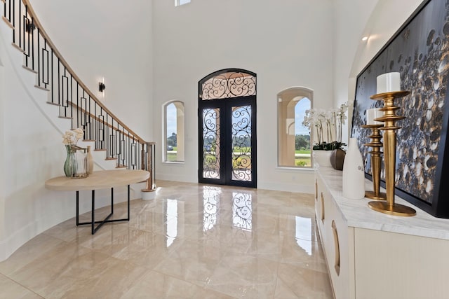 foyer featuring a high ceiling and french doors