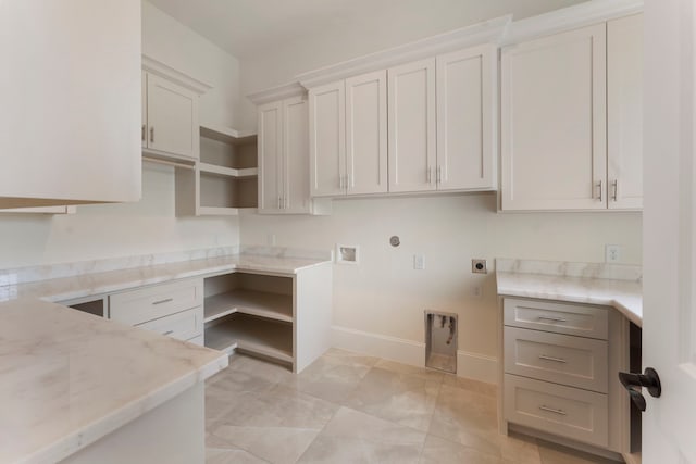 kitchen featuring white cabinets and light stone counters