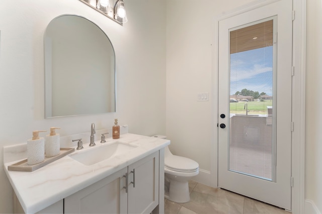 bathroom with toilet, tile patterned flooring, and vanity