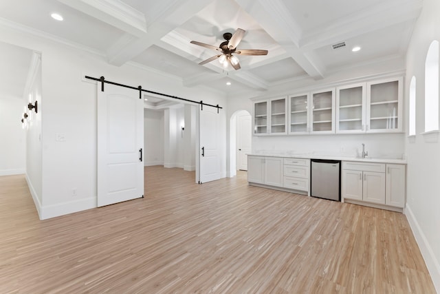 kitchen with a barn door, coffered ceiling, light wood-type flooring, beam ceiling, and white cabinets