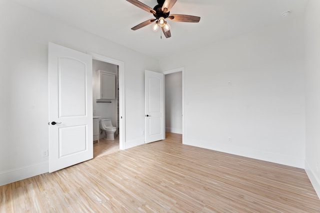 unfurnished bedroom with ceiling fan, light hardwood / wood-style flooring, and ensuite bath