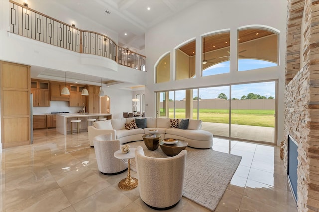 living room featuring a fireplace and a high ceiling