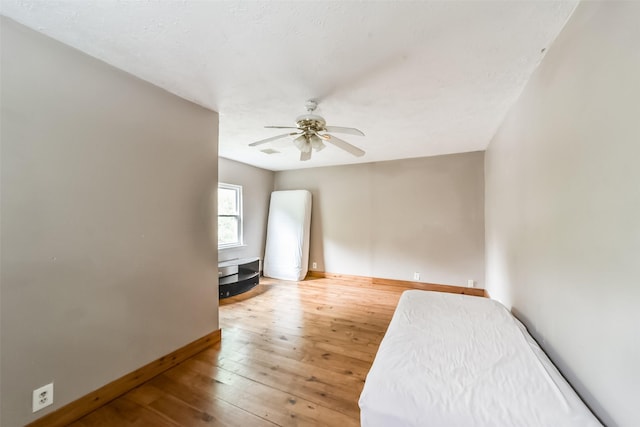 interior space with ceiling fan and wood-type flooring