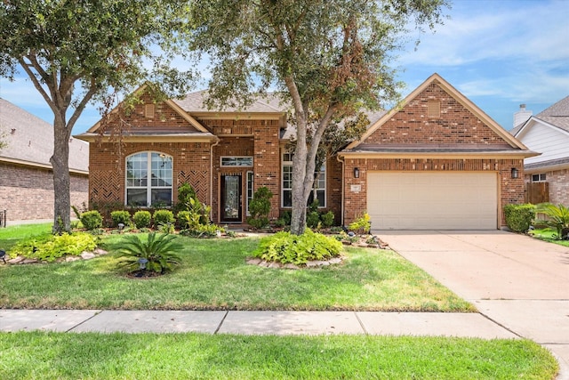 view of front of house with a garage and a front lawn