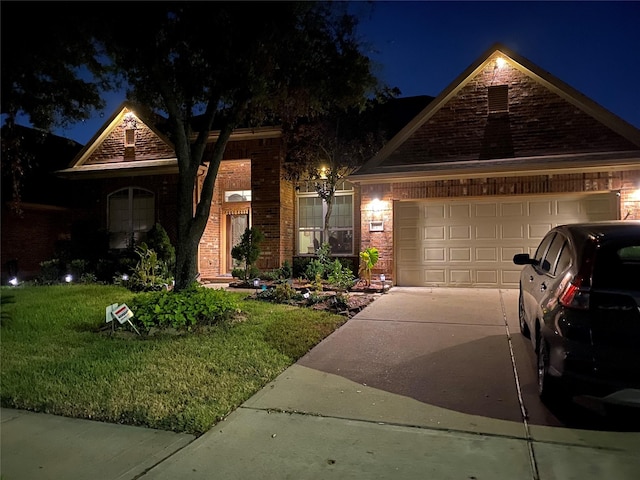 view of front of house featuring a garage and a yard