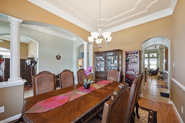 tiled dining area with a wealth of natural light, crown molding, and a chandelier