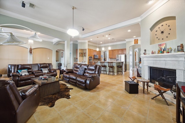 living room featuring light tile patterned floors and crown molding