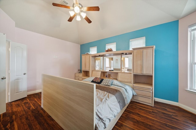 bedroom with dark hardwood / wood-style floors, ceiling fan, and vaulted ceiling