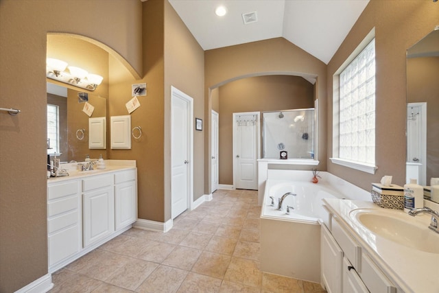 bathroom featuring tile patterned flooring, vanity, separate shower and tub, and lofted ceiling