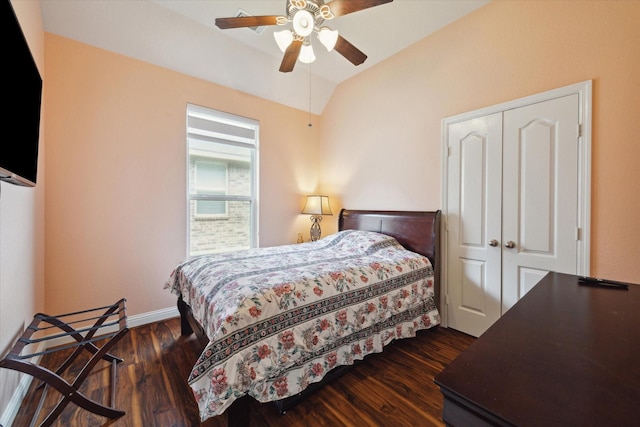 bedroom with ceiling fan, vaulted ceiling, dark wood-type flooring, and a closet