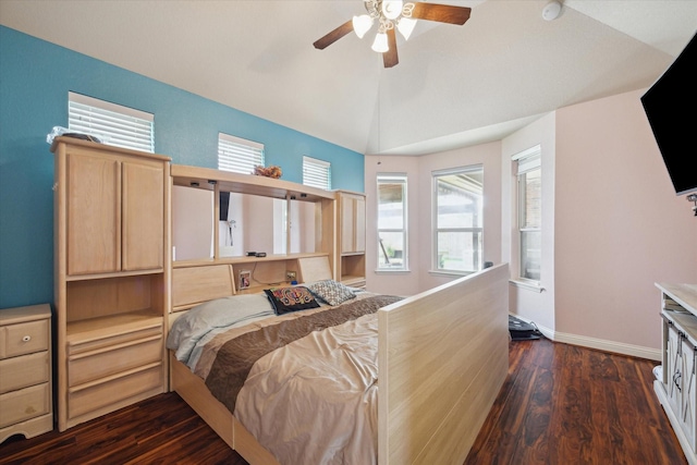 bedroom with dark hardwood / wood-style flooring, ceiling fan, and lofted ceiling