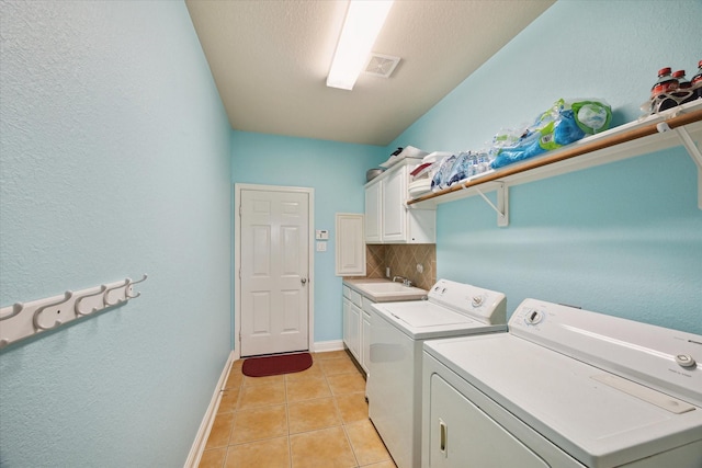 laundry room with cabinets, independent washer and dryer, sink, and light tile patterned floors