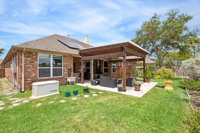 back of house with a lawn, outdoor lounge area, solar panels, a pergola, and a patio area