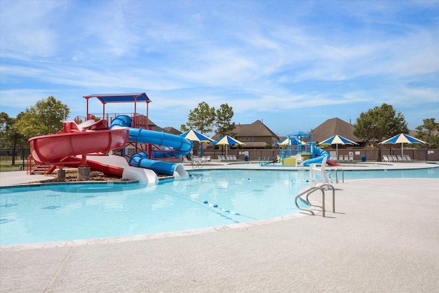 view of swimming pool with a water slide