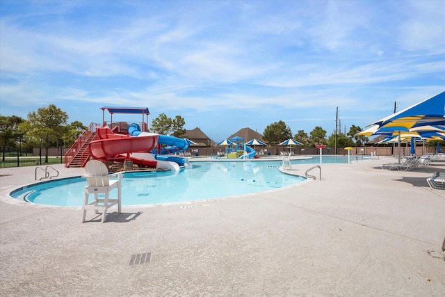 view of pool with a patio area and a water slide