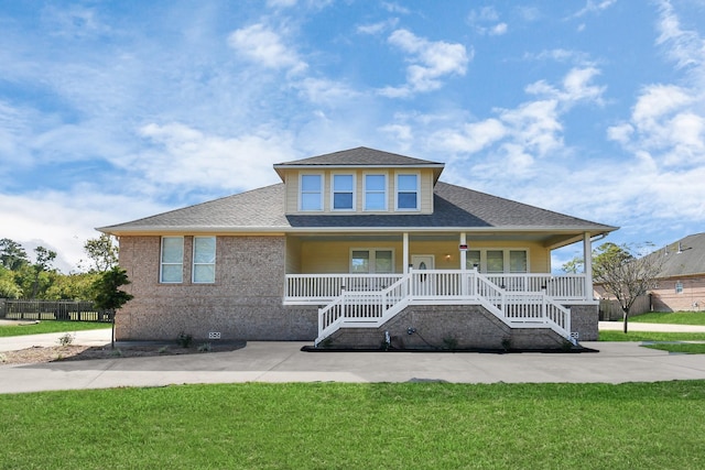 view of front facade with covered porch and a front yard