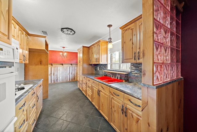 kitchen featuring white appliances, sink, crown molding, decorative backsplash, and decorative light fixtures