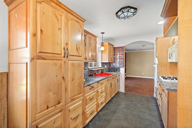 kitchen featuring white appliances, sink, ornamental molding, tasteful backsplash, and decorative light fixtures